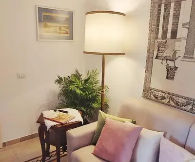 a living room with a couch and a lamp at Have a nice stay in Rome 2 in Rome