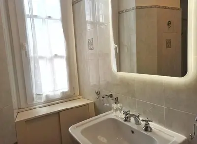 a bathroom with a sink and a mirror and a window at Have a nice stay in Rome 2 in Rome