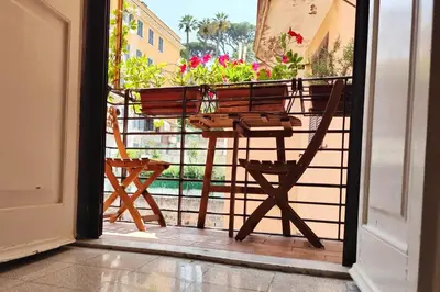 an open door with a chair and a table on a balcony at Have a nice stay in Rome 2 in Rome