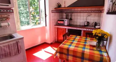 a kitchen with a table with a colorful table cloth at Have a nice stay in Rome 2 in Rome