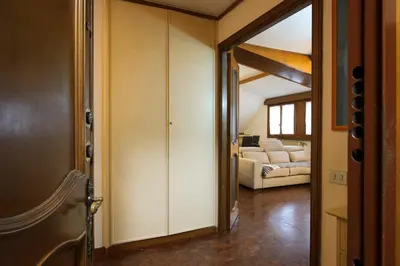 a hallway with a door leading to a living room at Casa Justa Anastasio in Rome