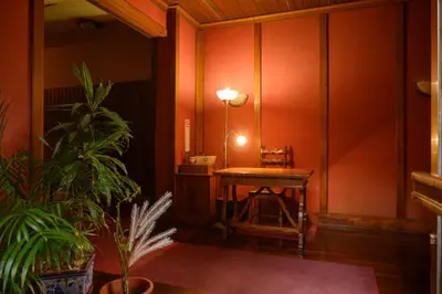 a room with a table and a lamp and plants at Casa Justa Anastasio in Rome