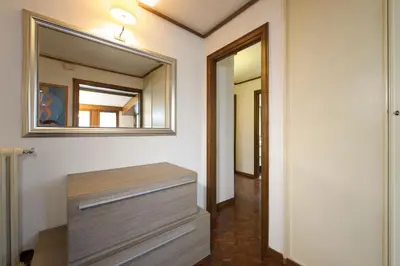a bathroom with a dresser and a mirror on the wall at Casa Justa Anastasio in Rome