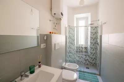 a bathroom with a toilet and a sink and a shower at Casa M.O.R.E. in Rome