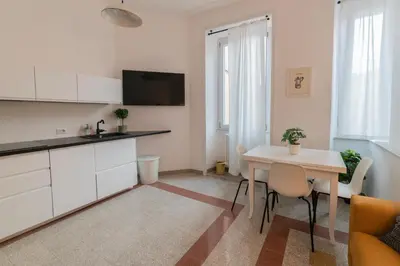 a kitchen and dining room with a table in a room at Vintage Giuliana Apartment in Rome