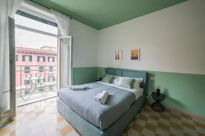 a bedroom with a large bed and a large window at Vintage Giuliana Apartment in Rome