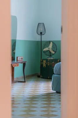 a living room with a couch and a table and a lamp at Vintage Giuliana Apartment in Rome