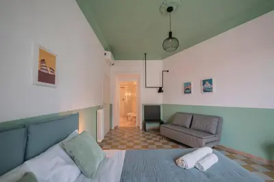 a bedroom with a bed and a couch and a chair at Vintage Giuliana Apartment in Rome