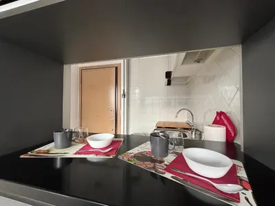 a kitchen counter with two white bowls on it at Terrace Suite Roma San Giovanni in Rome