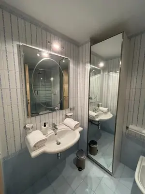 a bathroom with two sinks and a large mirror at Terrace Suite Roma San Giovanni in Rome