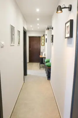 a hallway leading to a living room with white walls at FLOWER HOUSE in Rome
