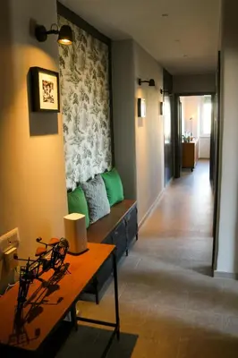 a living room with a green couch and a table at FLOWER HOUSE in Rome