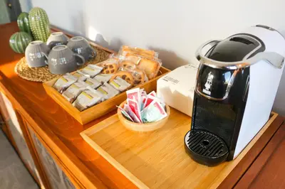 a coffee maker on a counter next to a tray of food at FLOWER HOUSE in Rome