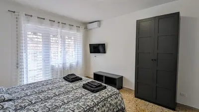 a bedroom with a bed and a dresser and a television at A casa nostra - Musei Vaticani in Rome