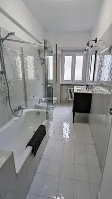 a white bathroom with a tub and a sink at A casa nostra - Musei Vaticani in Rome