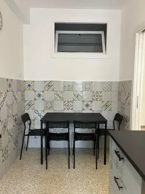 a dining room with a black table and chairs at A casa nostra - Musei Vaticani in Rome