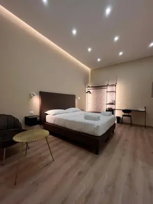 a large bedroom with a large bed and a couch at Colosseum Deluxe in Rome