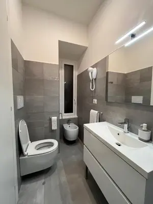 a bathroom with a toilet and a sink at Colosseum Deluxe in Rome