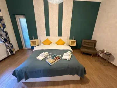 a bedroom with a bed with a tray of food on it at Il Giardino a Monte Sacro in Rome