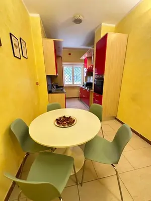 a kitchen with a table and chairs with a pizza on it at Il Giardino a Monte Sacro in Rome
