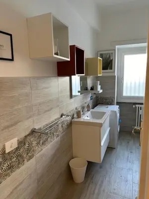 a small kitchen with a sink and a washing machine at Il Giardino a Monte Sacro in Rome