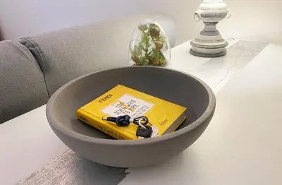 a bowl with a book and keys on a table at Via Giulia apartment / historic center of Rome in Rome