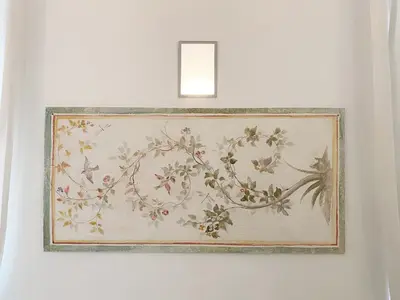 a picture of a painting on a wall with a light at Via Giulia apartment / historic center of Rome in Rome
