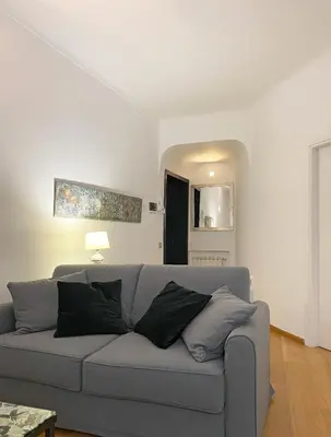 a living room with a gray couch and a table at Via Giulia apartment / historic center of Rome in Rome