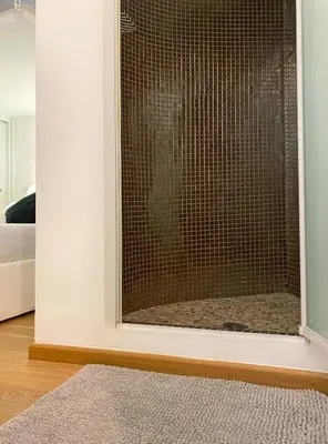 a glass door to a shower in a bedroom at Via Giulia apartment / historic center of Rome in Rome