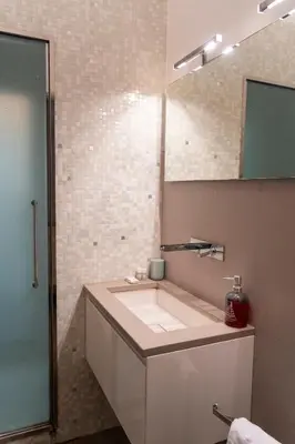 a bathroom with a white sink and a mirror at Regina Margherita Home in Rome
