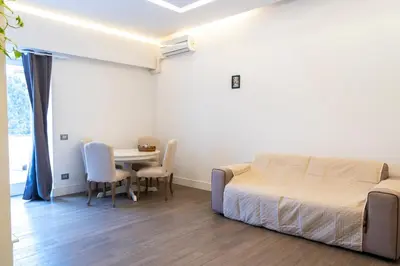a bedroom with a bed and a table and chairs at Regina Margherita Home in Rome
