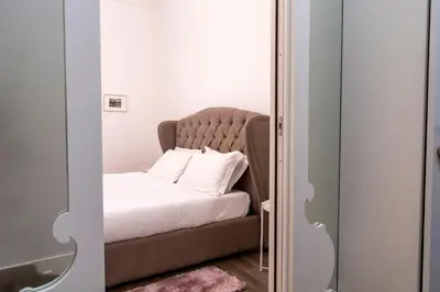 a bedroom with a bed with a headboard at Regina Margherita Home in Rome