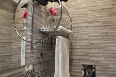 a bathroom with a towel rack and a sink at Argilla House 10 min a piedi dal Vaticano in Rome