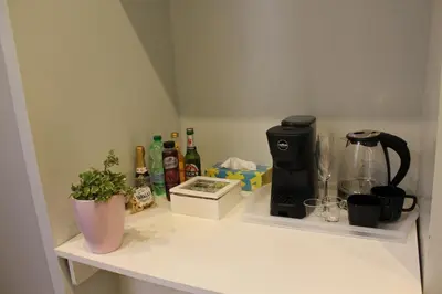 a kitchen counter with a coffee maker and drinks on it at Argilla House 10 min a piedi dal Vaticano in Rome