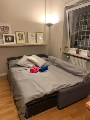a large bed in a bedroom with two clothes on it at NINA'S HOUSE in Rome