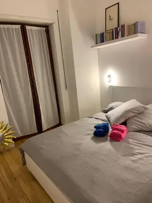 a bedroom with a bed with two towels on it at NINA'S HOUSE in Rome