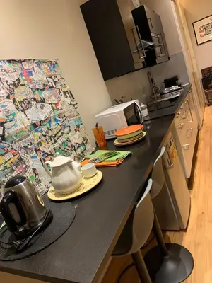 a kitchen with a black counter top with a microwave at NINA'S HOUSE in Rome