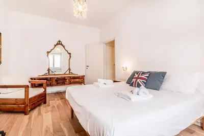 a bedroom with two beds and a mirror and a dresser at Retro design flat near Vaticano in Rome