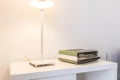 a desk with a lamp and books on it at Retro design flat near Vaticano in Rome