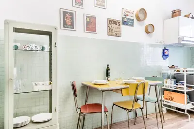a dining room with a table and chairs at Retro design flat near Vaticano in Rome