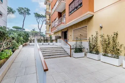 a building with stairs and plants in front of it at Retro design flat near Vaticano in Rome