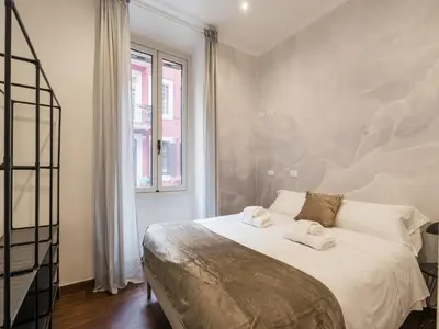 a bedroom with a bed with two towels on it at The Best Rent -Cozy two bedroom apartment near Vatican City in Rome