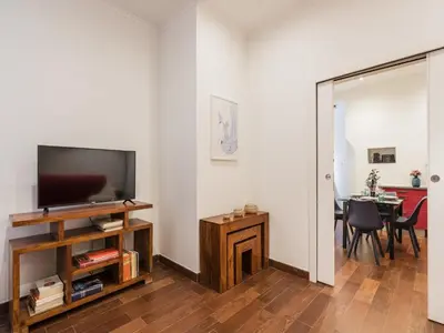 a living room with a flat screen tv and a table at The Best Rent -Cozy two bedroom apartment near Vatican City in Rome