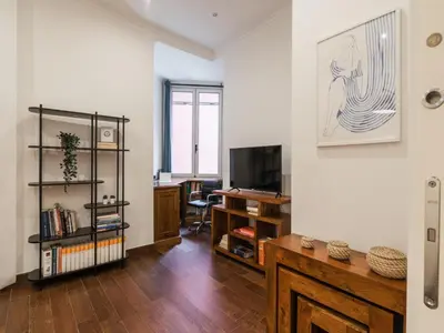 a living room with a television and a desk at The Best Rent -Cozy two bedroom apartment near Vatican City in Rome