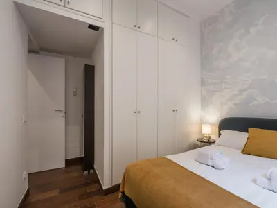 a bedroom with a large bed and white cabinets at The Best Rent -Cozy two bedroom apartment near Vatican City in Rome