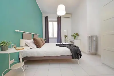 a bedroom with a bed and a desk in it at Casa Serafina in Prati district in Rome