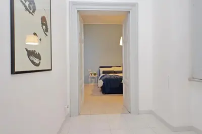 a hallway leading to a bedroom with a bed at Casa Serafina in Prati district in Rome