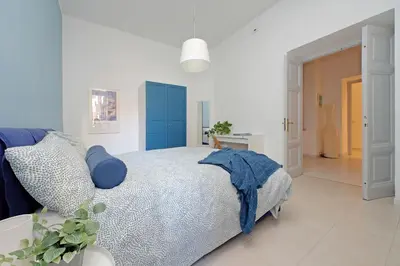 a bedroom with a bed and a blue cabinet at Casa Serafina in Prati district in Rome