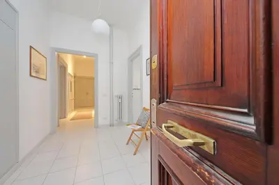 a wooden door in a room with a hallway at Casa Serafina in Prati district in Rome