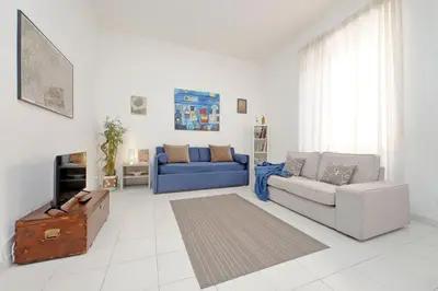 a living room with a couch and a blue couch at Casa Serafina in Prati district in Rome